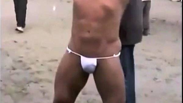 Muscled Asian Stud Bares Almost All at the Beach on girlsasian.net