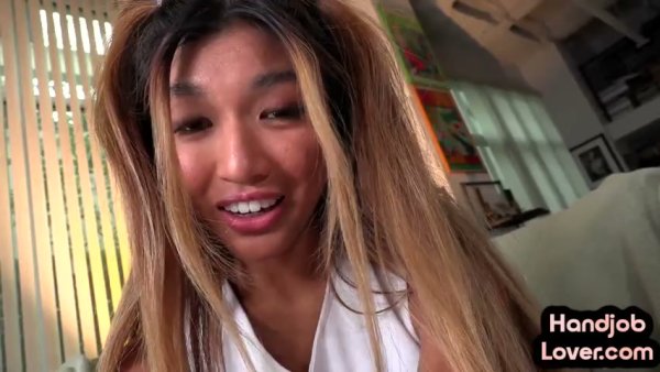 Asian cheerleader in purple skirt gives a passionate POV blowjob in the living room on girlsasian.net