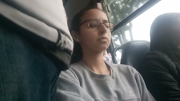 Young Brazilian woman with glasses rests on a bus while being subtly observed - Brazil - Portugal - county Young on girlsasian.net