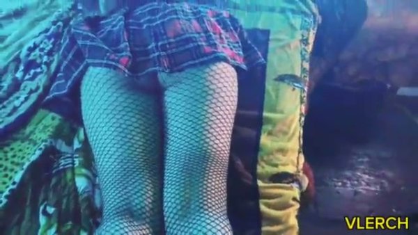 Young Latina otaku teases in fishnets and plaid under blue neon light on girlsasian.net