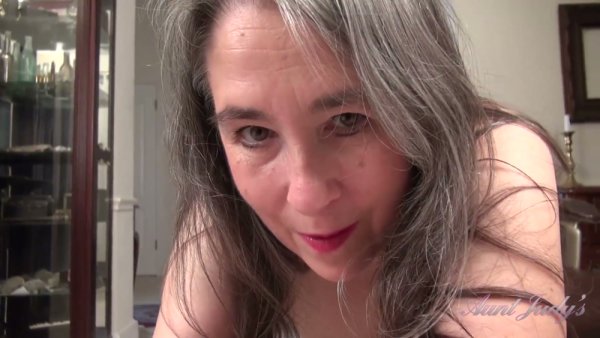 Mature gray-haired woman Grace proudly displays her natural hairy pussy in intimate solo scenes at home on girlsasian.net
