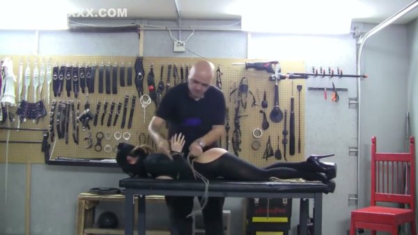 Blonde in bodystocking bound and gagged in a dungeon workshop on girlsasian.net