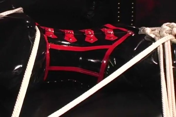 Black and red latex bondage session with restraints and rope harness on girlsasian.net