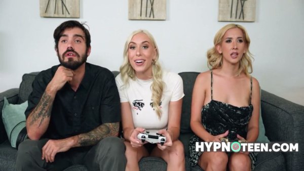 Two blonde babes under hypnosis yield to a tattooed man during an addictive game on girlsasian.net