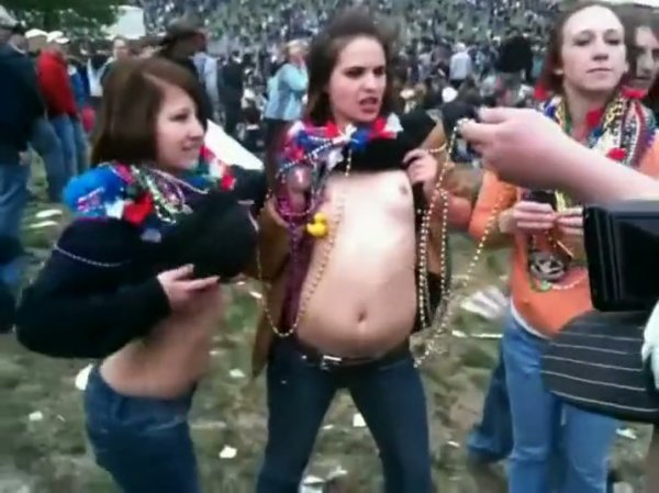 Group gathers in park as woman lets her top be lifted off by companions on girlsasian.net